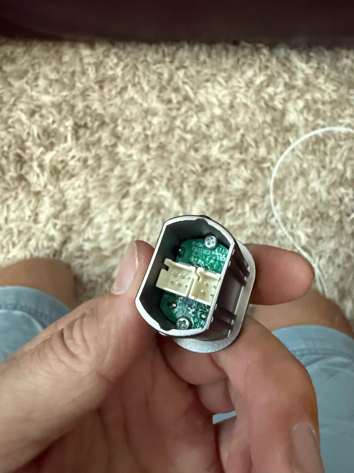 Recliner button module opened to expose its small circuit board