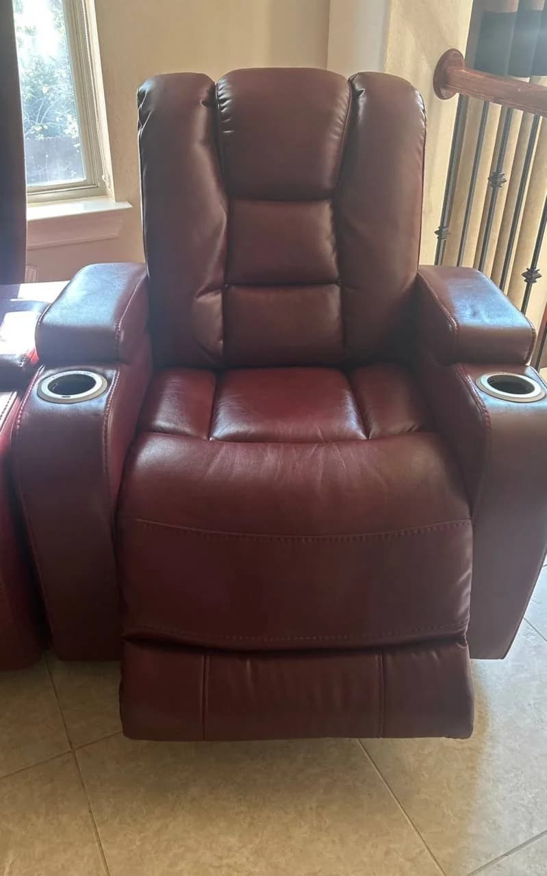 Red power recliner photographed with the footrest extended