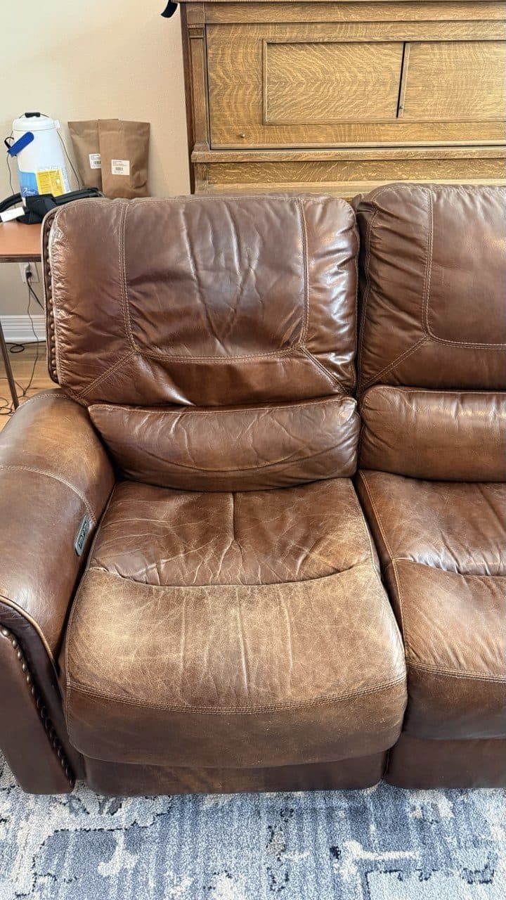 Before: Three-cushion reclining couch with the color rubbed thin across the seats